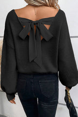 Pull noir à manches lanternes, col en V, nœud au dos