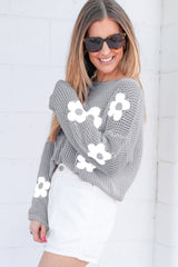Light gray sweater with drooping shoulders in openwork knitting with large flowers