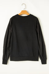Plain black sweatshirt with patchwork sleeves and round neck