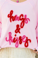 Sudadera rosa con manga raglán abrazos y besos bordados