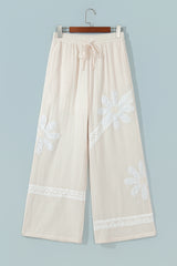 Pantalon large blanc en coton à dentelle florale