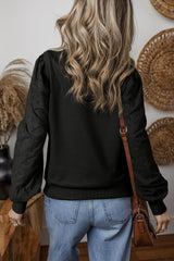 Plain black sweatshirt with patchwork sleeves and round neck