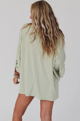 Green ribbed oversized top with rolled up sleeves and chest pocket