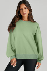 High-low drop-shoulder sweatshirt with solid fleece lining in grass green