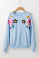 Pull bleu clair à motif fleuri et finitions côtelées