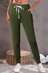 Foam green jogging pants with pockets at the waist and tightening cord