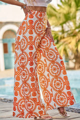 Grandes pantalones de naranja con estampado floral bohemio retro