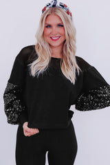 Blouse noire à manches lanternes et patchwork de sequins-A WOMAN WE LOVE