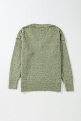 Pull ample vert jungle à col V et détails à œillets