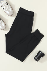 Black jogging pants with pockets at the waist and tightening cord