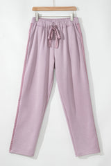 High waist pants with tightening cord and orchid petals, satin striped patch, right leg
