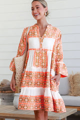 V -neck orange dress and ruffle buttons and geometric print