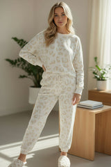 Living room set with white leopard sweater and tightening cord pants