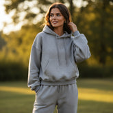 Set of plain gray sports clothes with hooded sweatshirt and jogging pants with falling shoulders