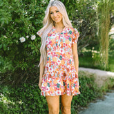 Purple floral print dress with split neck and flowing sleeves