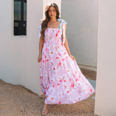 Long pink dress with floral print and knotted shoulders