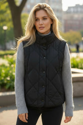Black quilted vest coat with high collar and buttoned pocket