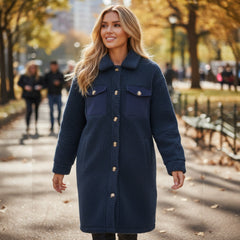 Blue teddy coat with simple buttoning and contrasting flap pocket