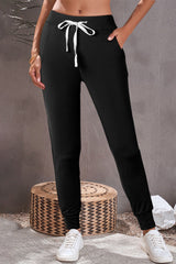 Black jogging pants with pockets at the waist and tightening cord