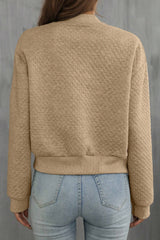 Pale khaki jacket with textured and geometric baseball collar