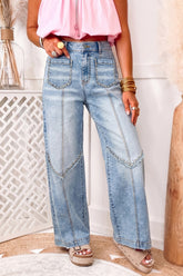 Jean large bleu délavé à taille haute, poches cloutées et détails effilochés