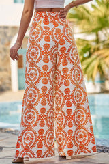 Grandes pantalones de naranja con estampado floral bohemio retro