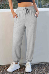 Light gray drawstring waist jogging pants with solid color fleece lining