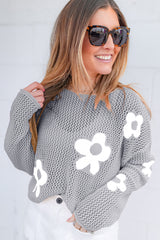 Light gray sweater with drooping shoulders in openwork knitting with large flowers