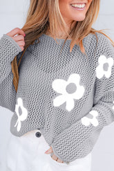 Light gray sweater with drooping shoulders in openwork knitting with large flowers