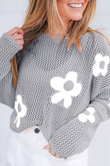 Light gray sweater with drooping shoulders in openwork knitting with large flowers