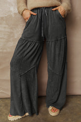Pantalon large noir délavé à empiècements et coutures apparentes