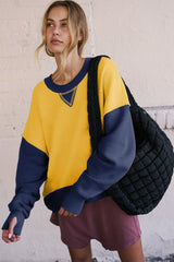 Sweat-shirt jaune à épaules tombantes et manches avec trou pour le pouce