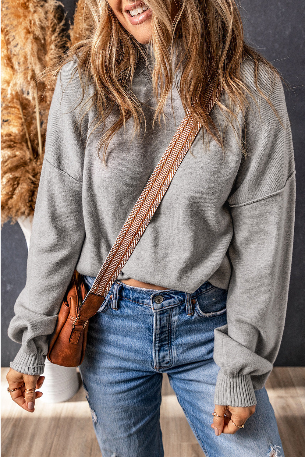 Grey turtleneck knit sweater with dropped shoulders and bubble sleeves