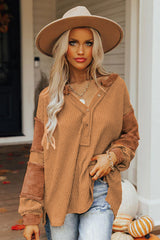 Waffle knit henley top with exposed seams and orange contrast patches