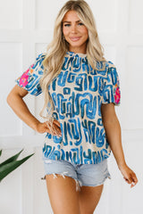 Haut imprimé beige brodé à manches bouffantes *