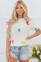White sweater with short sleeves and knitted uphill collar with colorful knot