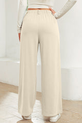 Pantalon large beige à taille élastique texturée de couleur unie