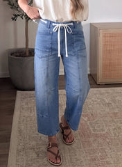 Jean ample bleu à taille haute, cordon et œillets, longueur cheville