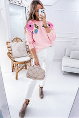 Suéter de punto rosa con bordes acanalados y motivo de flores