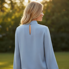 Pleated asymmetrical blouse with turtleneck *