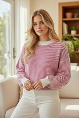 Loose-fitting sweater with contrasting edges in a textured knit with bright pink stripes
