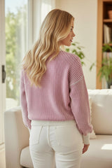 Loose-fitting sweater with contrasting edges in a textured knit with bright pink stripes