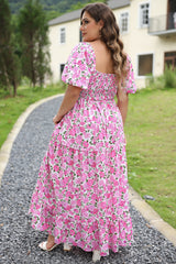 Smocked pink dress with puffy sleeves and large floral print