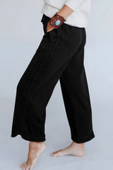 Black wide leg pants with mineral wash and visible stitching