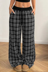 Pantalon large noir à carreaux, taille élastiquée et cordon contrasté