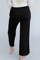 Black wide leg pants with mineral wash and visible stitching