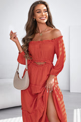 Long orange dress with bare shoulders and ruffled cut -off ball sleeves