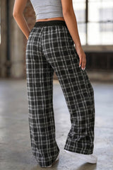Pantalon large noir à carreaux, taille élastiquée et cordon contrasté