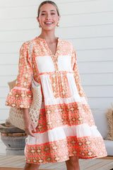 V -neck orange dress and ruffle buttons and geometric print